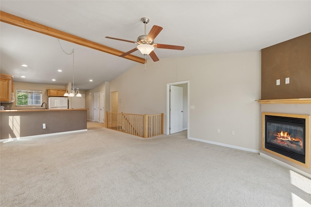 209 E Nicklaus Ave, Kalispell, MT 59901 - unfurnished living room featuring a glass covered fireplace, light colored carpet, lofted ceiling, recessed lighting, and a ceiling fan
