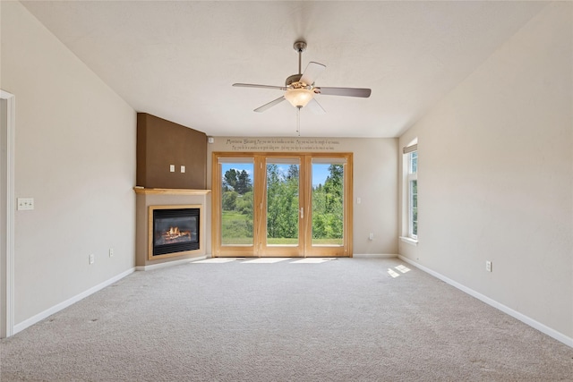 209 E Nicklaus Ave, Kalispell, MT 59901 - unfurnished living room featuring ceiling fan, a glass covered fireplace, and carpet flooring