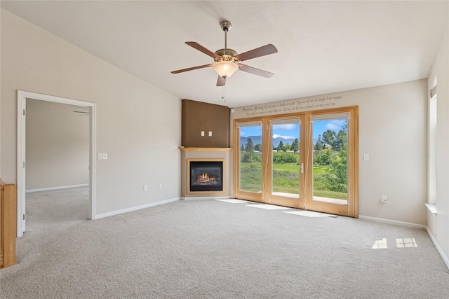 209 E Nicklaus Ave, Kalispell, MT 59901 - unfurnished living room with carpet flooring, ceiling fan, a glass covered fireplace, and lofted ceiling