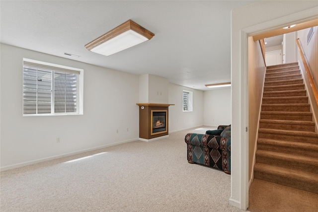 209 E Nicklaus Ave, Kalispell, MT 59901 - living area featuring carpet flooring, stairs, and a glass covered fireplace