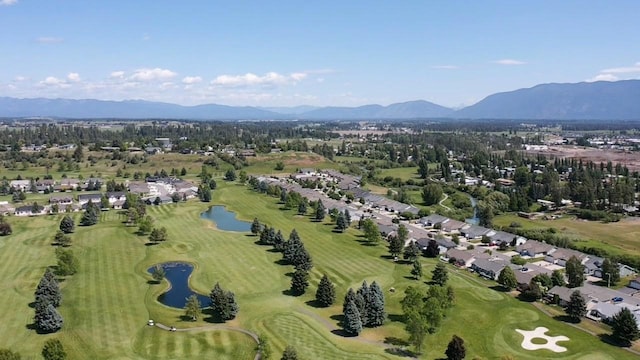 209 E Nicklaus Ave, Kalispell, MT 59901 - aerial overview of property's location featuring a water and mountain view, nearby suburban area, and a golf club