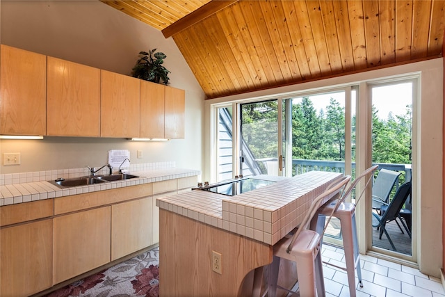 100 Deep Bay Dr, Lakeside, MT 59922 - kitchen with tile countertops, wooden ceiling, healthy amount of natural light, and light brown cabinetry