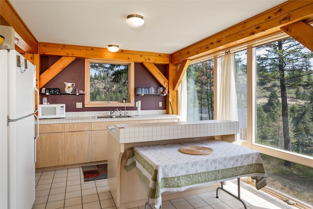100 Deep Bay Dr, Lakeside, MT 59922 - kitchen with white appliances, tile countertops, light tile patterned flooring, and light brown cabinets