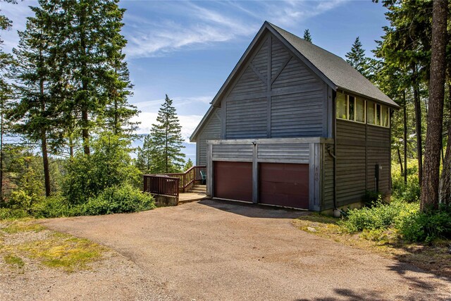 100 Deep Bay Dr, Lakeside, MT 59922 - view of side of home featuring driveway and a detached garage