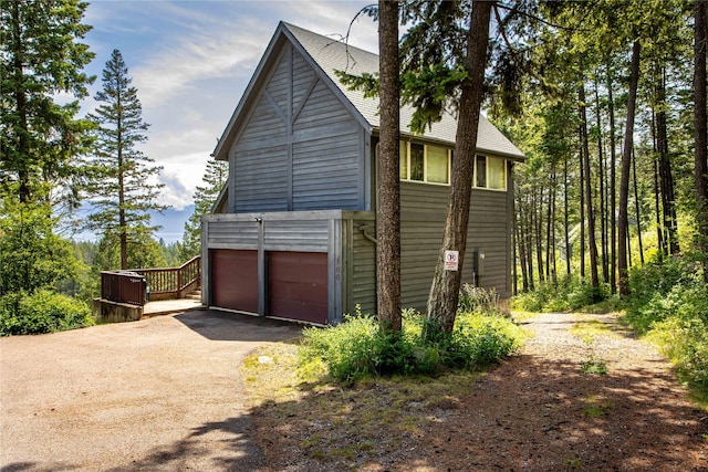 100 Deep Bay Dr, Lakeside, MT 59922 - view of side of property with driveway and an attached garage