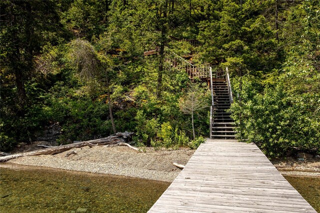 100 Deep Bay Dr, Lakeside, MT 59922 - dock featuring stairway and a wooded view