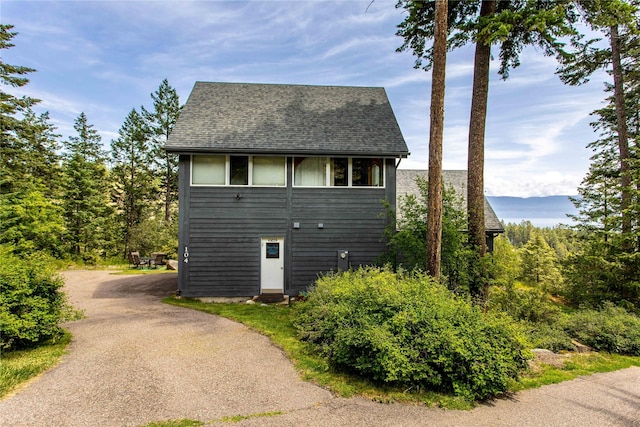 100 Deep Bay Dr, Lakeside, MT 59922 - view of side of property with roof with shingles and asphalt driveway