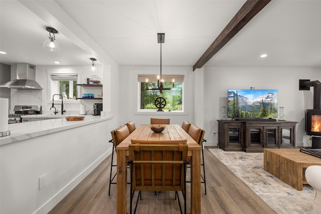 441/443 Karrow Ave, Whitefish, MT 59937 - dining space featuring a wood stove, wood finished floors, beam ceiling, and recessed lighting