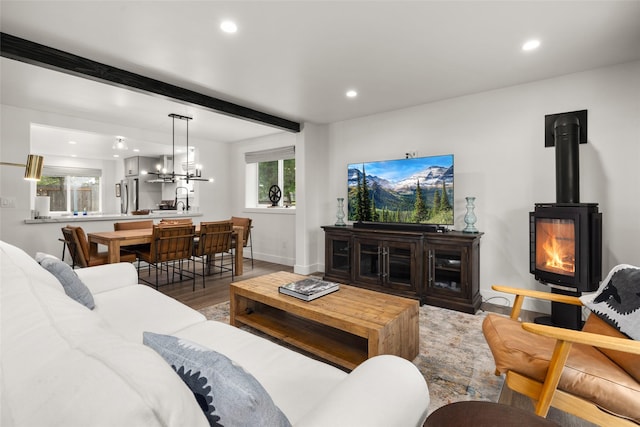 441/443 Karrow Ave, Whitefish, MT 59937 - living area featuring recessed lighting, wood finished floors, beamed ceiling, a wood stove, and a chandelier