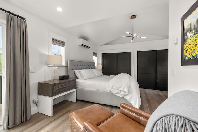 441/443 Karrow Ave, Whitefish, MT 59937 - bedroom featuring a wall mounted air conditioner, a chandelier, recessed lighting, light wood-type flooring, and vaulted ceiling