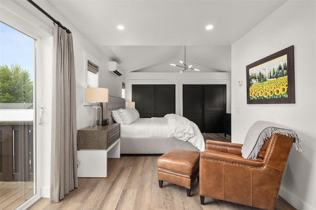 441/443 Karrow Ave, Whitefish, MT 59937 - bedroom featuring wood finished floors, lofted ceiling, an AC wall unit, and recessed lighting