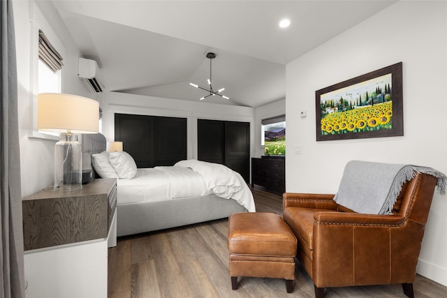 441/443 Karrow Ave, Whitefish, MT 59937 - bedroom with a wall mounted AC, a chandelier, vaulted ceiling, wood finished floors, and recessed lighting