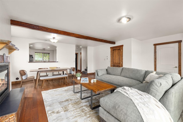 441/443 Karrow Ave, Whitefish, MT 59937 - living room featuring beamed ceiling, wood finished floors, a glass covered fireplace, and arched walkways