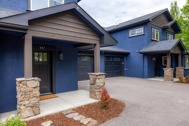 441/443 Karrow Ave, Whitefish, MT 59937 - view of front of property featuring driveway, stucco siding, and an attached garage