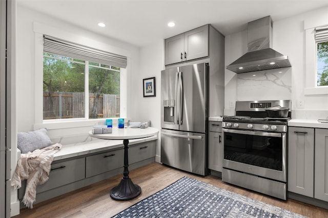 441/443 Karrow Ave, Whitefish, MT 59937 - kitchen with stainless steel appliances, gray cabinets, wall chimney range hood, and recessed lighting