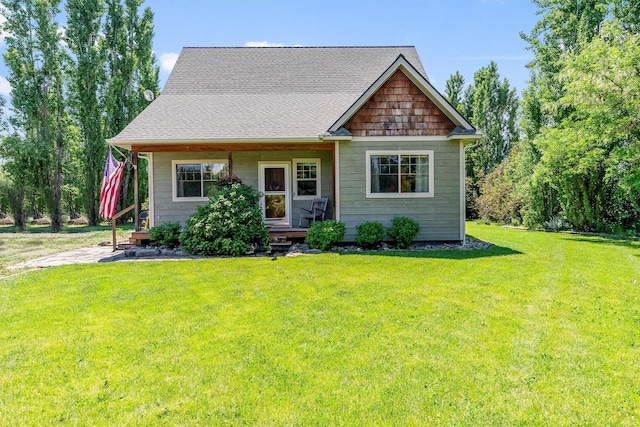 5014 Eastside Hwy, Stevensville, MT 59870 - view of front of house featuring a front yard, a porch, and a shingled roof
