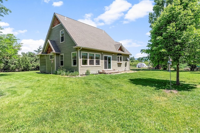 5014 Eastside Hwy, Stevensville, MT 59870 - rear view of house with a shingled roof and a lawn