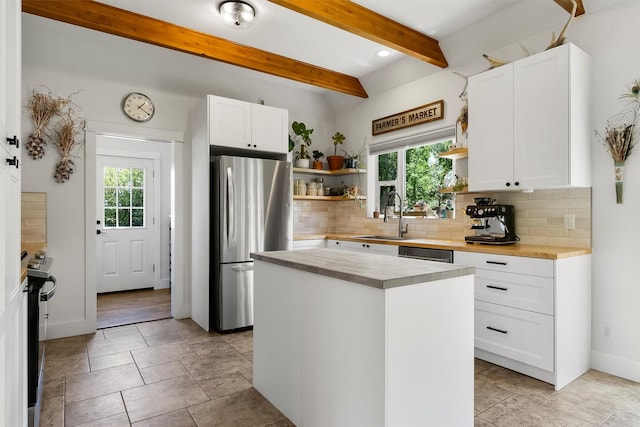 5014 Eastside Hwy, Stevensville, MT 59870 - kitchen with freestanding refrigerator, wood counters, open shelves, plenty of natural light, and beamed ceiling