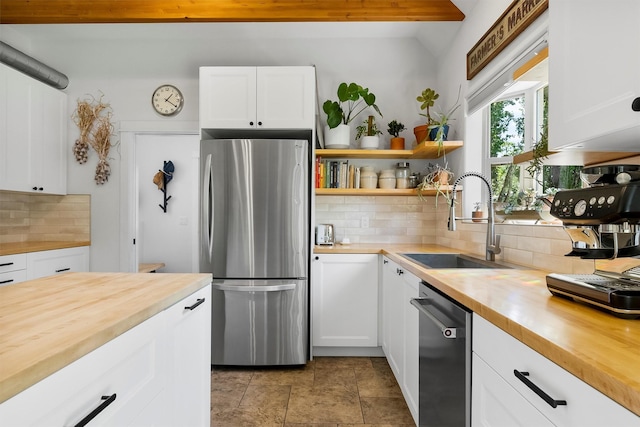 5014 Eastside Hwy, Stevensville, MT 59870 - kitchen with appliances with stainless steel finishes, butcher block counters, and backsplash