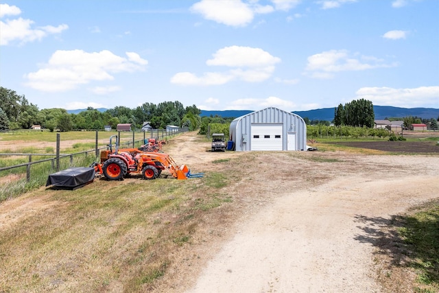 5014 Eastside Hwy, Stevensville, MT 59870 - view of yard with an outbuilding, driveway, a detached garage, a rural view, and a mountain view