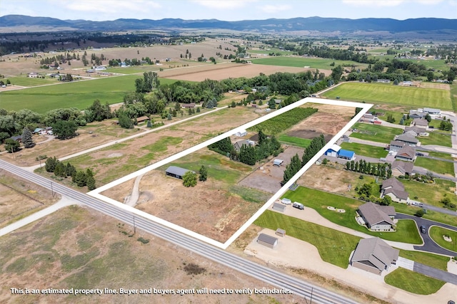 5014 Eastside Hwy, Stevensville, MT 59870 - overview of rural landscape with property boundaries highlighted and a mountain backdrop