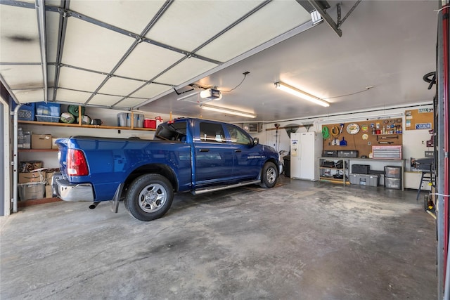 305 S Dell Dr, Havre, MT 59501 - garage with a garage door opener and white fridge with ice dispenser