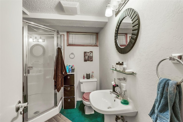 305 S Dell Dr, Havre, MT 59501 - bathroom featuring a shower stall, a textured ceiling, and a textured wall