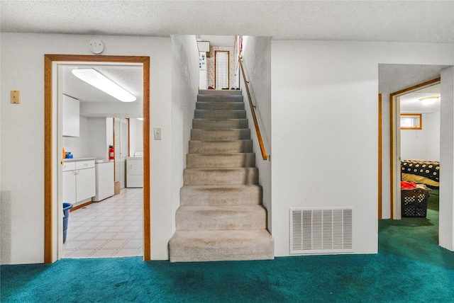 305 S Dell Dr, Havre, MT 59501 - stairs featuring washer / clothes dryer, tile patterned floors, and a textured ceiling