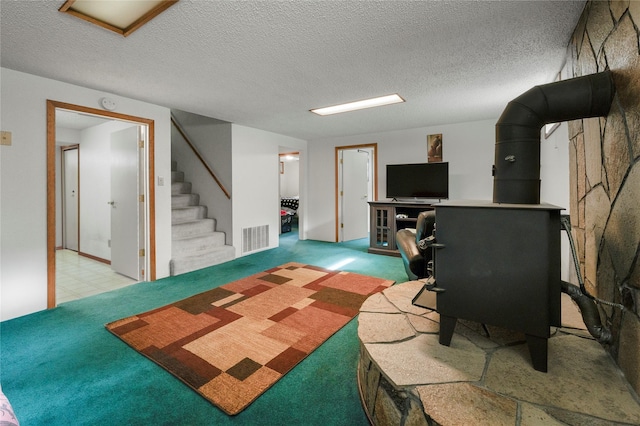 305 S Dell Dr, Havre, MT 59501 - living room with a wood stove, stairway, carpet, and a textured ceiling