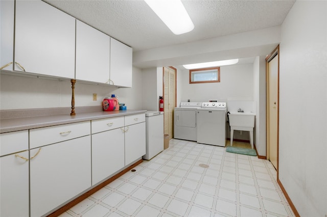 305 S Dell Dr, Havre, MT 59501 - laundry room with washer and clothes dryer, light floors, cabinet space, and a textured ceiling