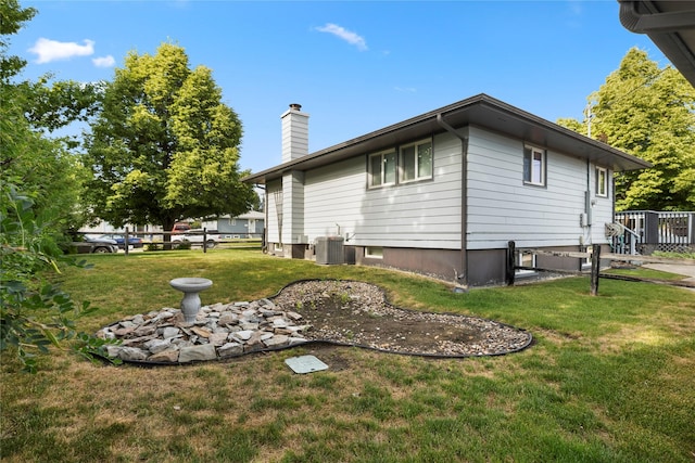 305 S Dell Dr, Havre, MT 59501 - view of property exterior with a chimney and a yard