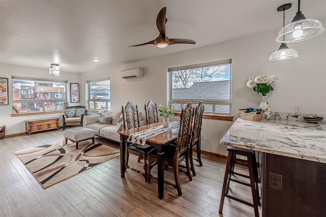 620 Phillips St Unit B, Missoula, MT 59802 - dining area featuring a wall mounted AC, light wood-type flooring, and a ceiling fan