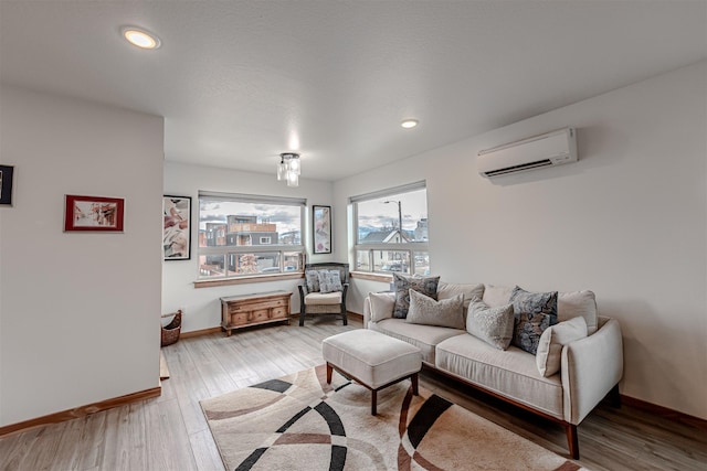 620 Phillips St Unit B, Missoula, MT 59802 - living room with a wall unit AC, wood finished floors, and recessed lighting
