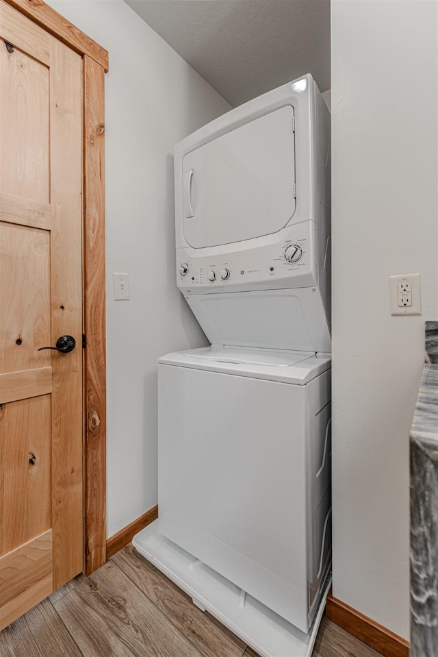 620 Phillips St Unit B, Missoula, MT 59802 - laundry room featuring stacked washer and clothes dryer and wood finished floors
