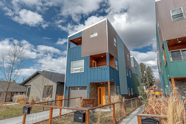 620 Phillips St Unit B, Missoula, MT 59802 - contemporary house featuring board and batten siding, an attached garage, a balcony, and driveway