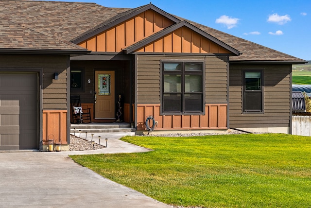 9 Blue Stem Way, Three Forks, MT 59752 - property entrance featuring board and batten siding, roof with shingles, a lawn, and concrete driveway