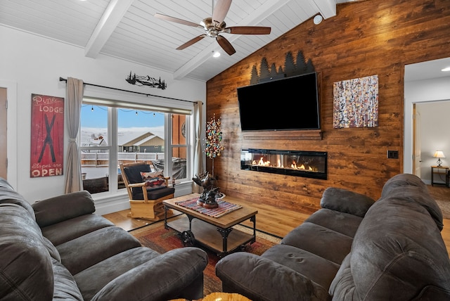 9 Blue Stem Way, Three Forks, MT 59752 - living room featuring wood walls, a large fireplace, wood finished floors, and a ceiling fan