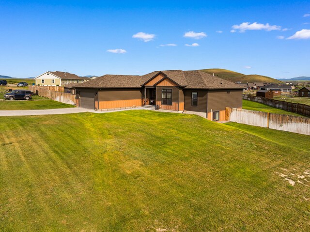 9 Blue Stem Way, Three Forks, MT 59752 - view of front of property featuring concrete driveway, a garage, board and batten siding, and a mountain view