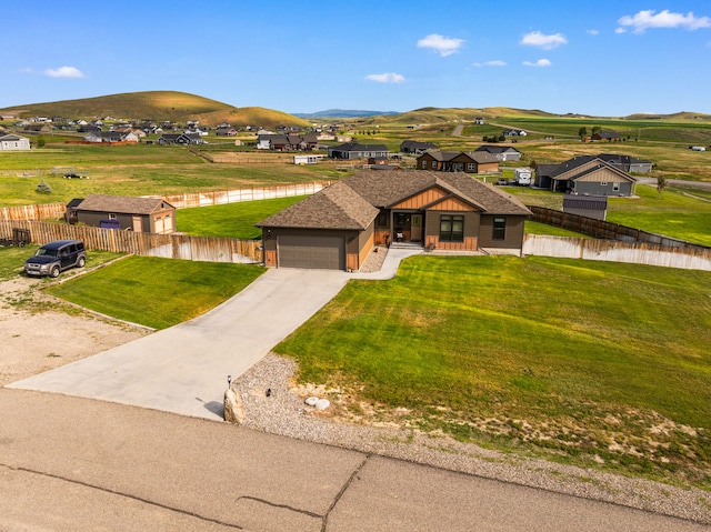 9 Blue Stem Way, Three Forks, MT 59752 - view of front of house with a garage, concrete driveway, a mountain view, and a residential view