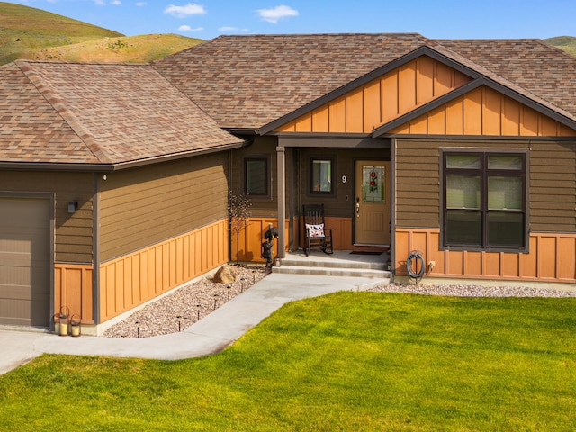9 Blue Stem Way, Three Forks, MT 59752 - view of front of home with roof with shingles, a front lawn, board and batten siding, and a garage