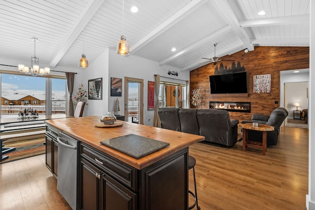 9 Blue Stem Way, Three Forks, MT 59752 - kitchen with butcher block countertops, wooden walls, a chandelier, light wood finished floors, and a large fireplace