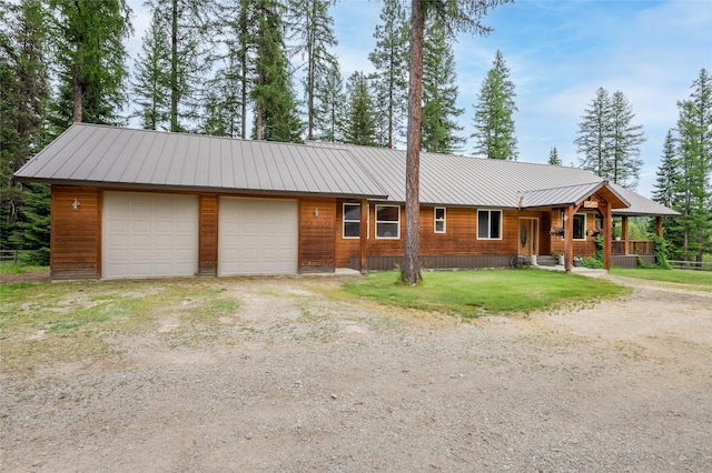 6611 Packer Creek Rd, Haugan, MT 59842 - view of front of house with a metal roof, a front lawn, and a porch