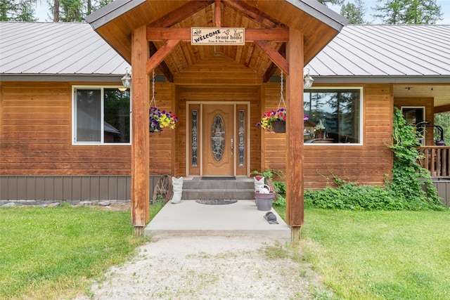 6611 Packer Creek Rd, Haugan, MT 59842 - doorway to property with a standing seam roof, a metal roof, and a yard
