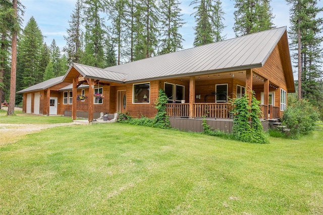 6611 Packer Creek Rd, Haugan, MT 59842 - view of front of house with a porch, a front yard, and a metal roof