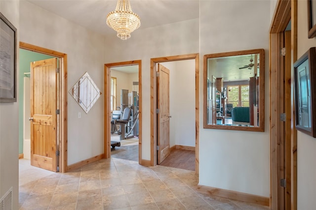 6611 Packer Creek Rd, Haugan, MT 59842 - hall featuring a chandelier and baseboards
