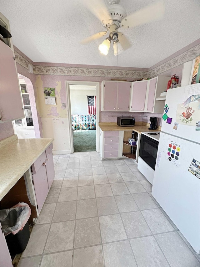 214 2nd Ave SW, Cut Bank, MT 59427 - kitchen featuring white appliances, open shelves, a textured ceiling, light countertops, and a ceiling fan