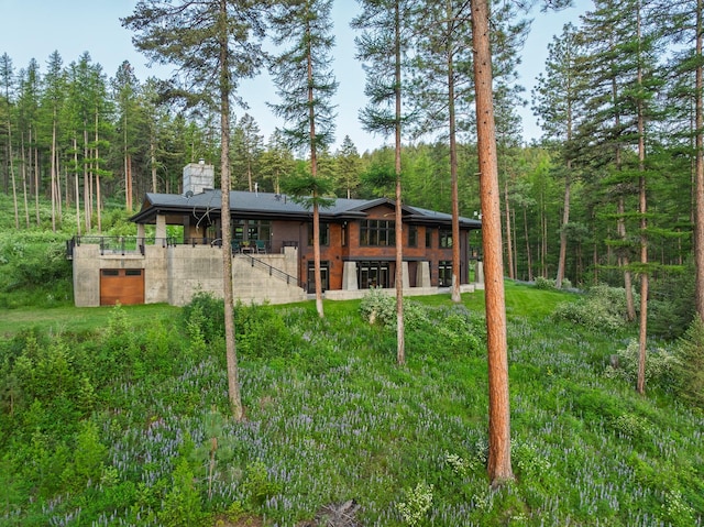 6601 Russian Joe Rd, Missoula, MT 59802 - back of property with a wooded view and a chimney