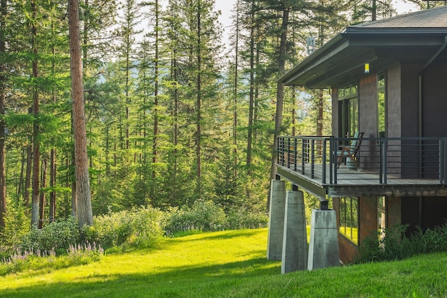 6601 Russian Joe Rd, Missoula, MT 59802 - view of grassy yard with a forest view and a deck