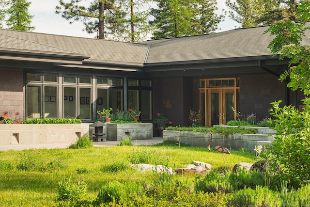 6601 Russian Joe Rd, Missoula, MT 59802 - back of house with roof with shingles, french doors, and concrete block siding