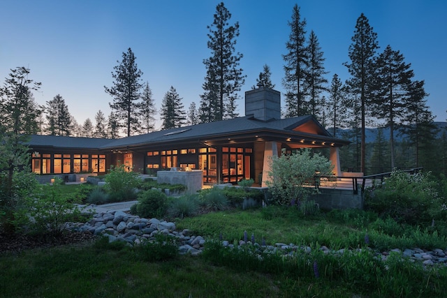 6601 Russian Joe Rd, Missoula, MT 59802 - back of property at dusk with a chimney and a metal roof